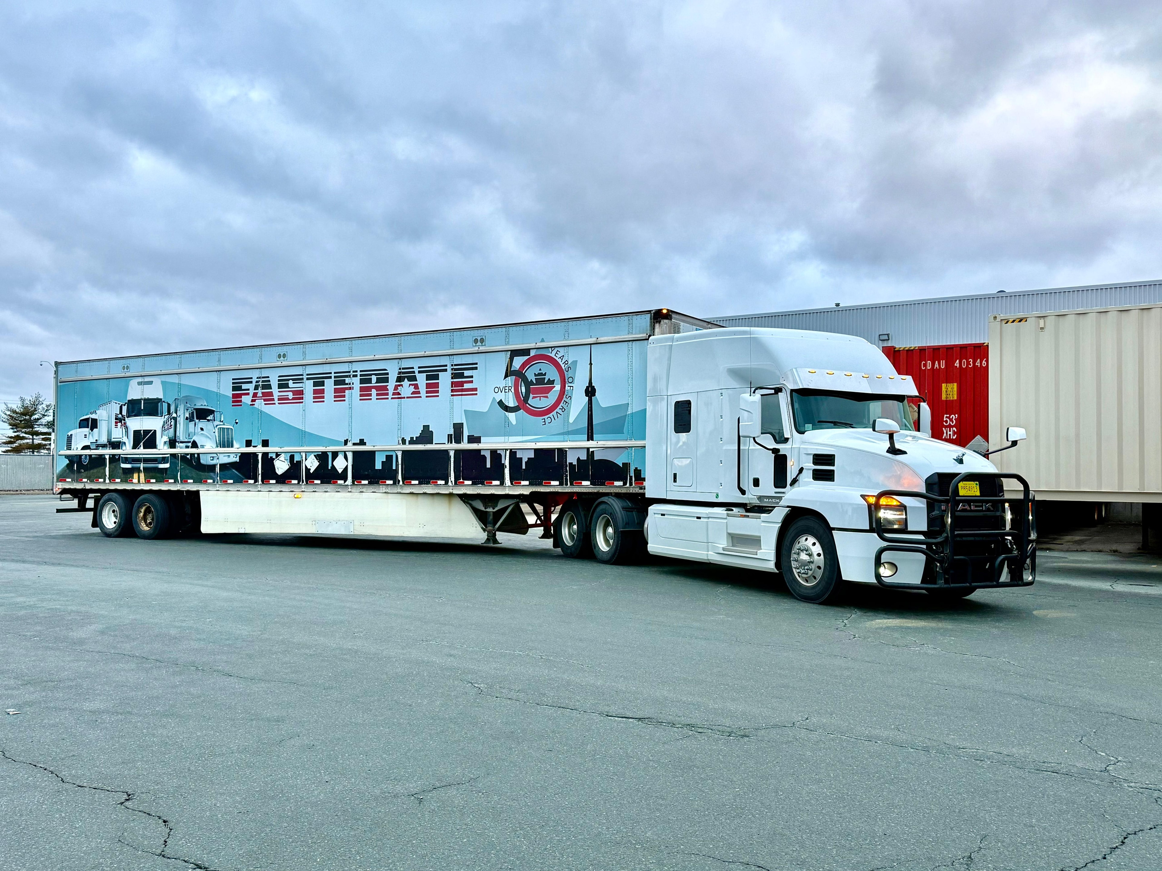 Mack truck with Fastrate trailer at logistics yard